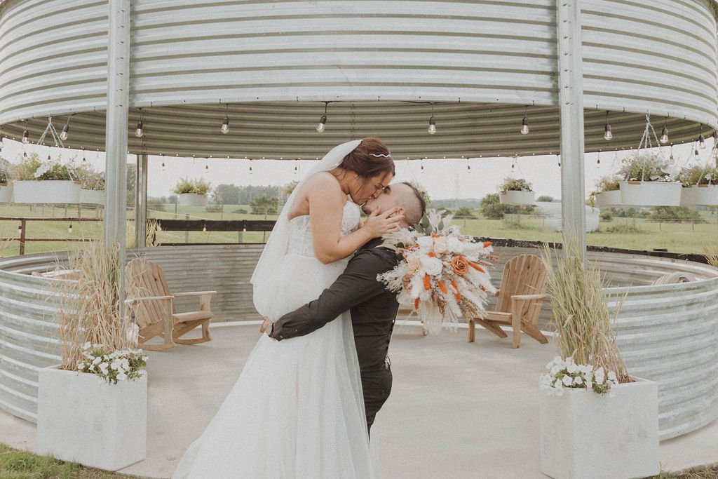 Bride and groom in front of grain bin silo at Columbus Ohio wedding venue
