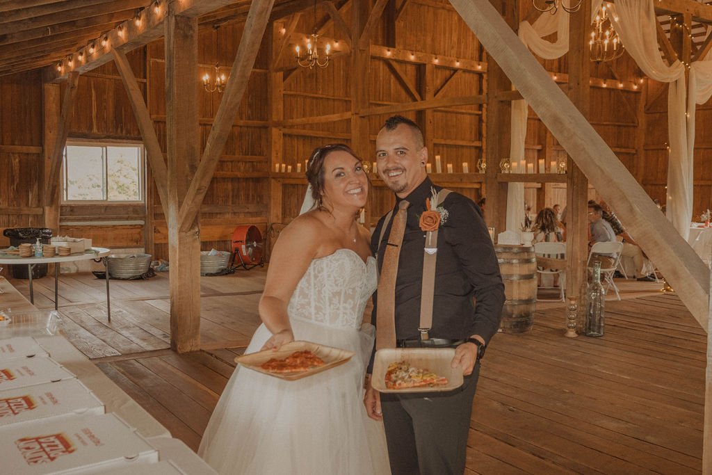 Bride and groom with pizza at Columbus Ohio rustic barn country wedding