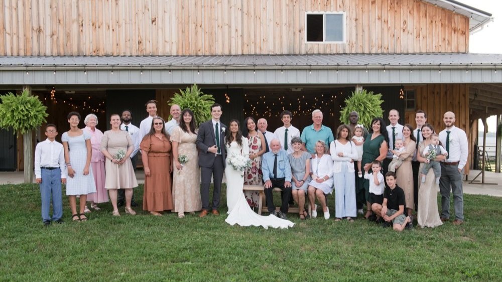 Bride and groom with their family at their private countryside wedding reception
