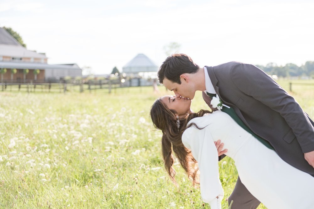 Bride and groom kissing in the countryside