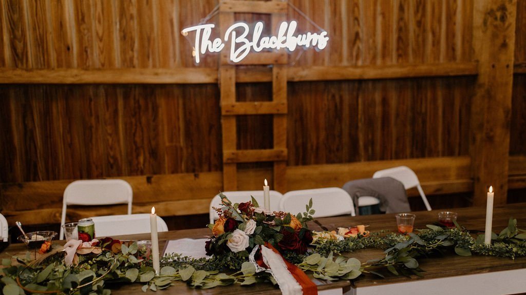 neon last name sign at a wedding in a barn venue