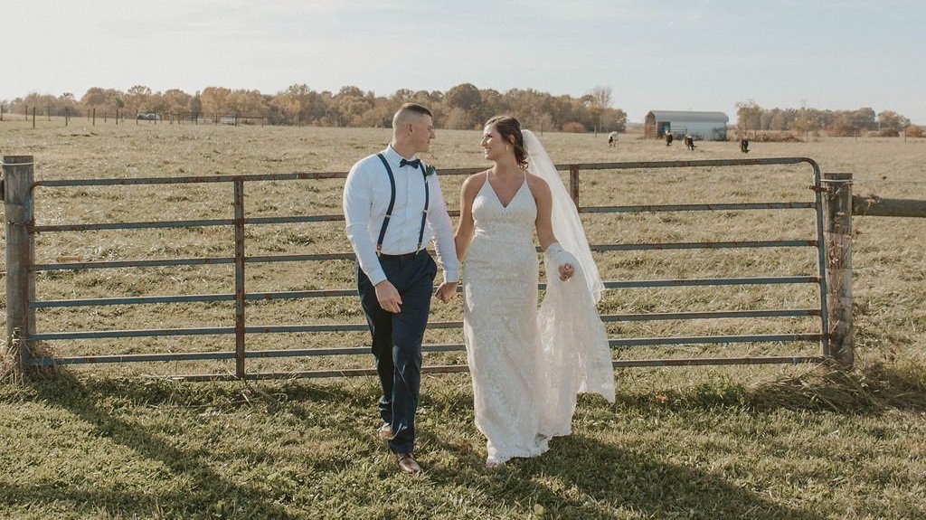 Bride and groom walking through Ohio farmlands