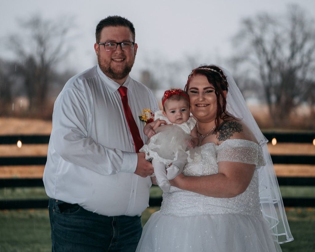 bride, groom, and baby in Columbus Ohio countryside wedding venue