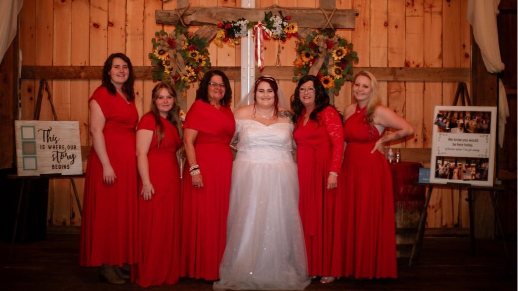bridal party with rustic barn backdrop