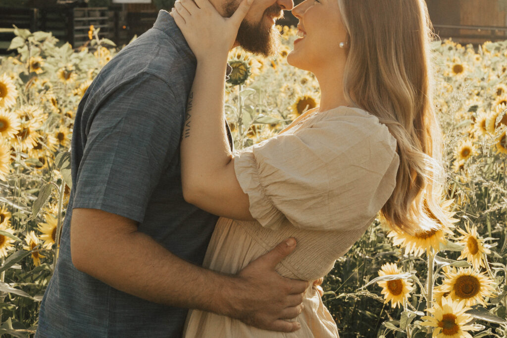 A couple embracing in a field of sunflowers