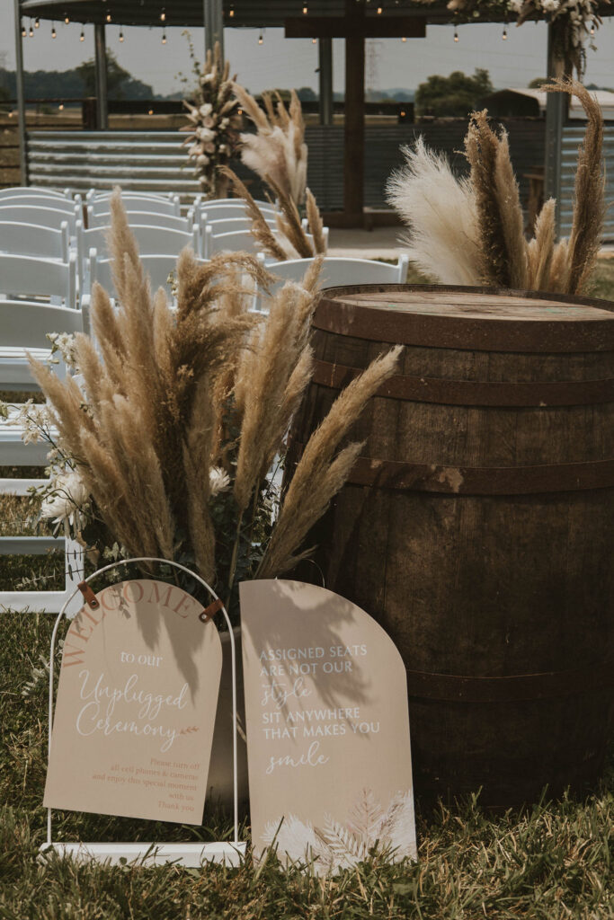 natural decor with a whiskey barrel at a barnyard wedding outside Columbus, Ohio