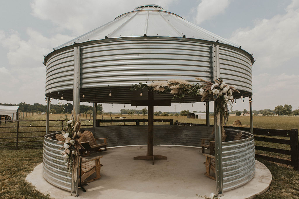 Grain bin gazebo backdrop for an outdoor western themed wedding at 22 Acres Farm outside Columbus, Ohio.