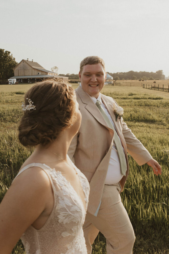 A couple walking hand in hand at their western wedding through the Columbus, Ohio countryside