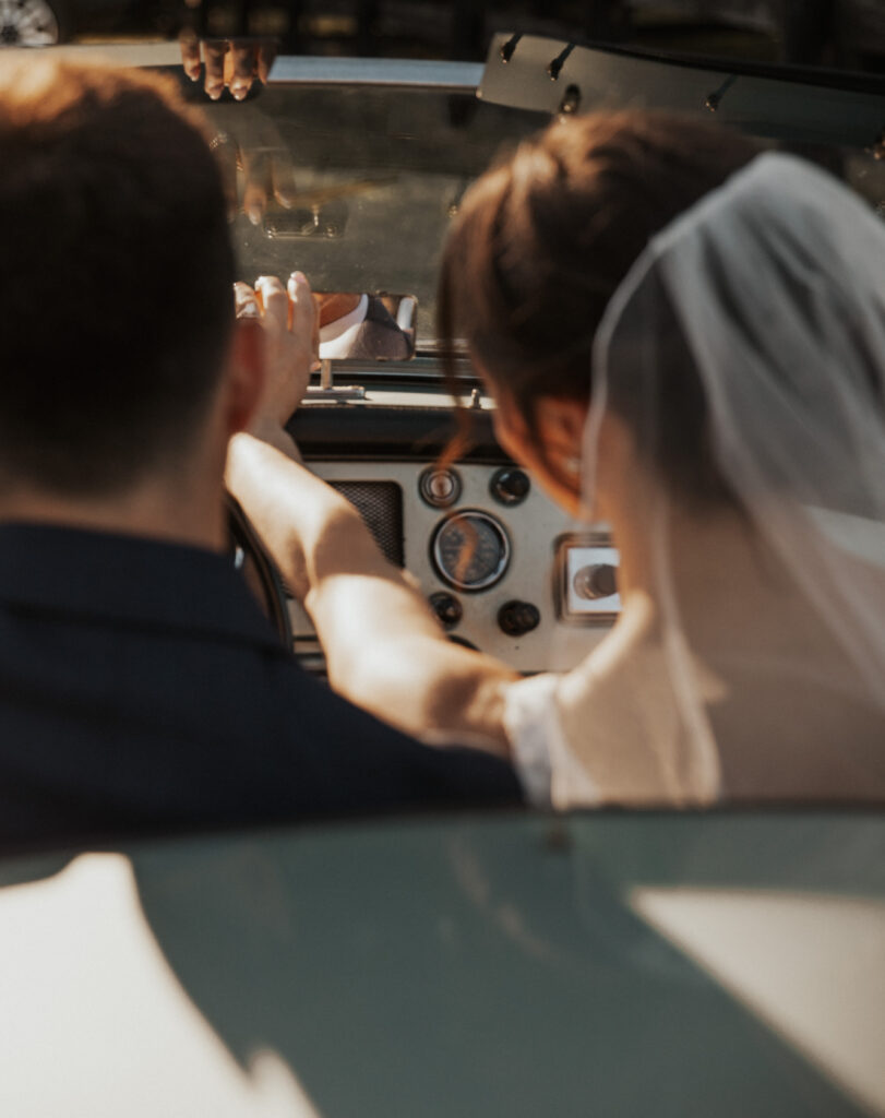 A bride adjusting the rear view mirror