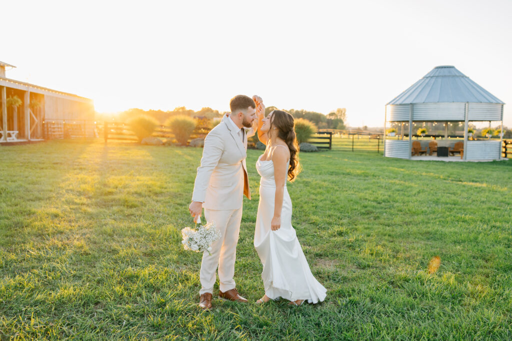 Couple in front of grain bin gazebo at a wedding venue with lots of photo opportunities near Columbus Ohio