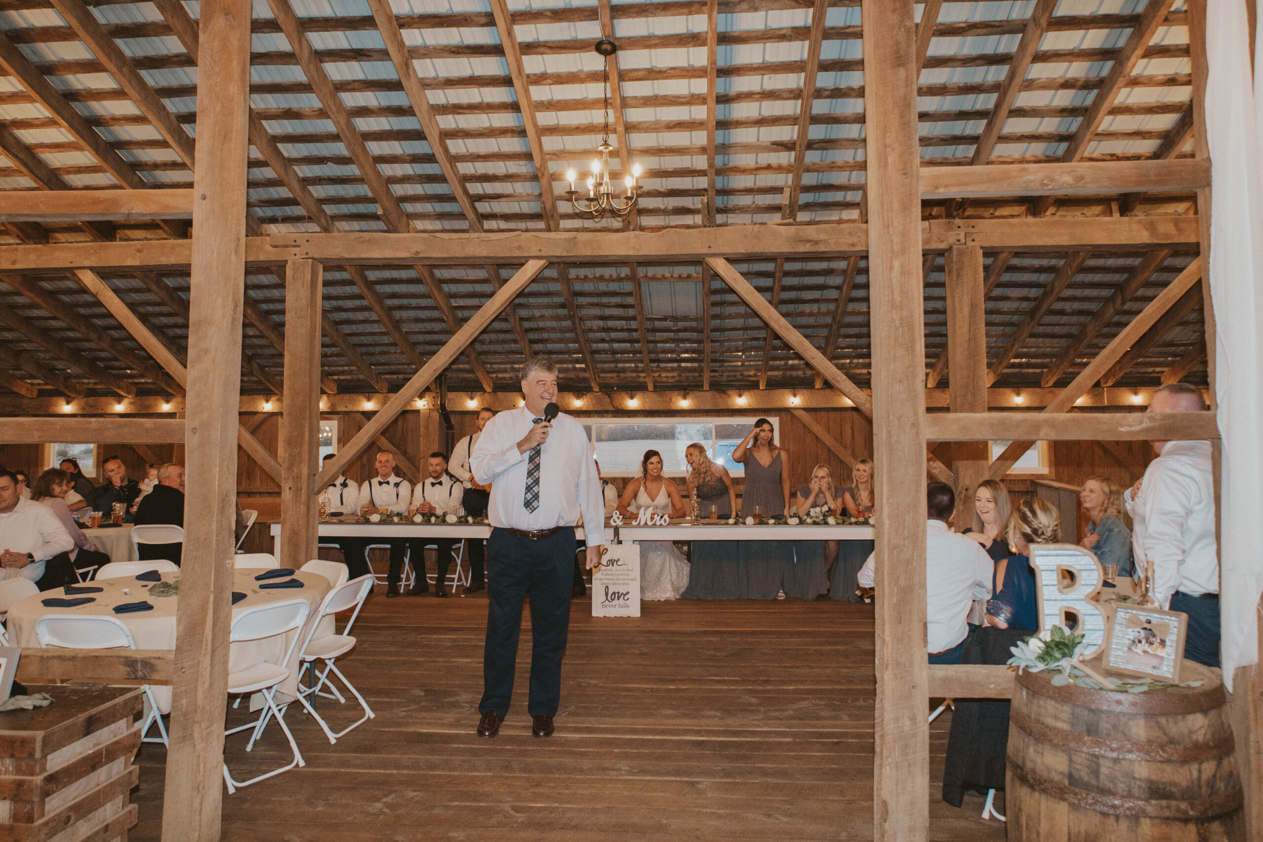 A proud father delivering a heartfelt wedding speech, sharing cherished memories of his daughter on her big day.