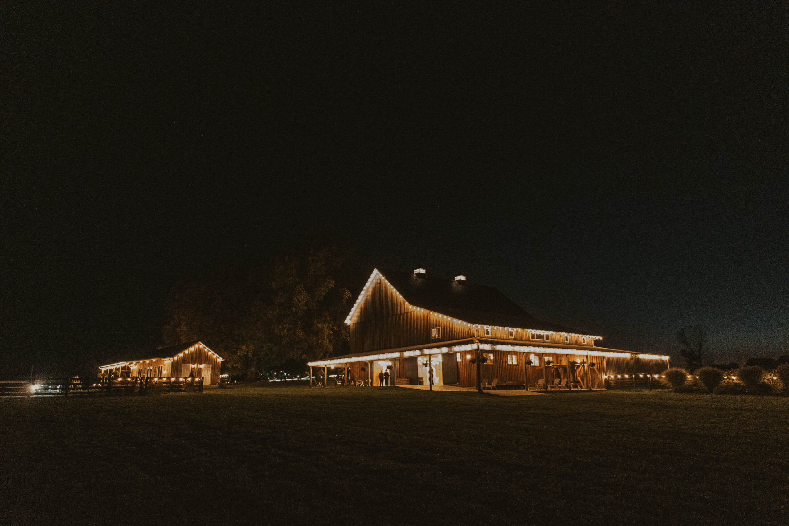 Elegant wedding venue in Columbus, Ohio, illuminated at night with warm lighting, showcasing a rustic yet modern ambiance perfect for a romantic celebration.