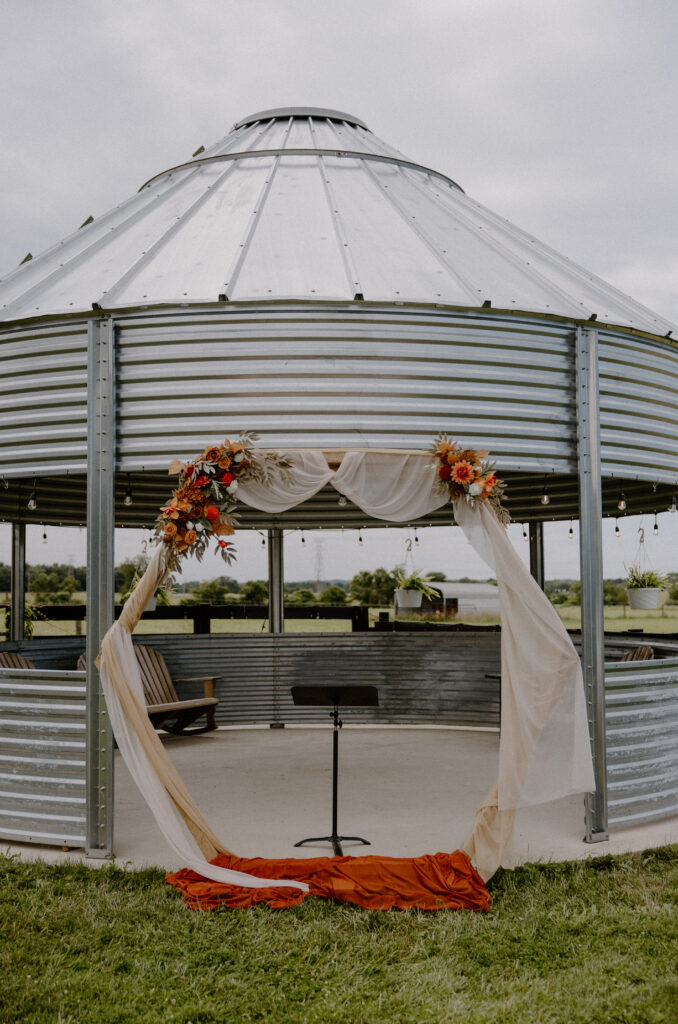 Grain bin gazebo backdrop with a hexagonal arch at a Columbus, Ohio wedding.