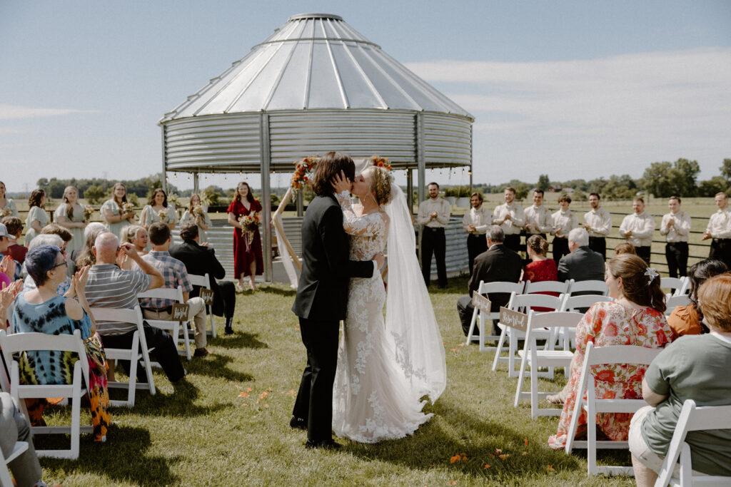 A bride and groom kiss after their rustic Columbus, Ohio wedding ceremony last June at 22 Acres Farm.