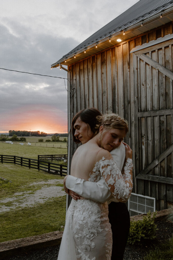 a bride and groom embrace at 22 Acres Farm, a Columbus, Ohio wedding venue.